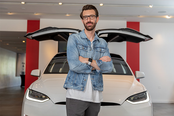 Ryan Day standing in front of a Model X at Tesla